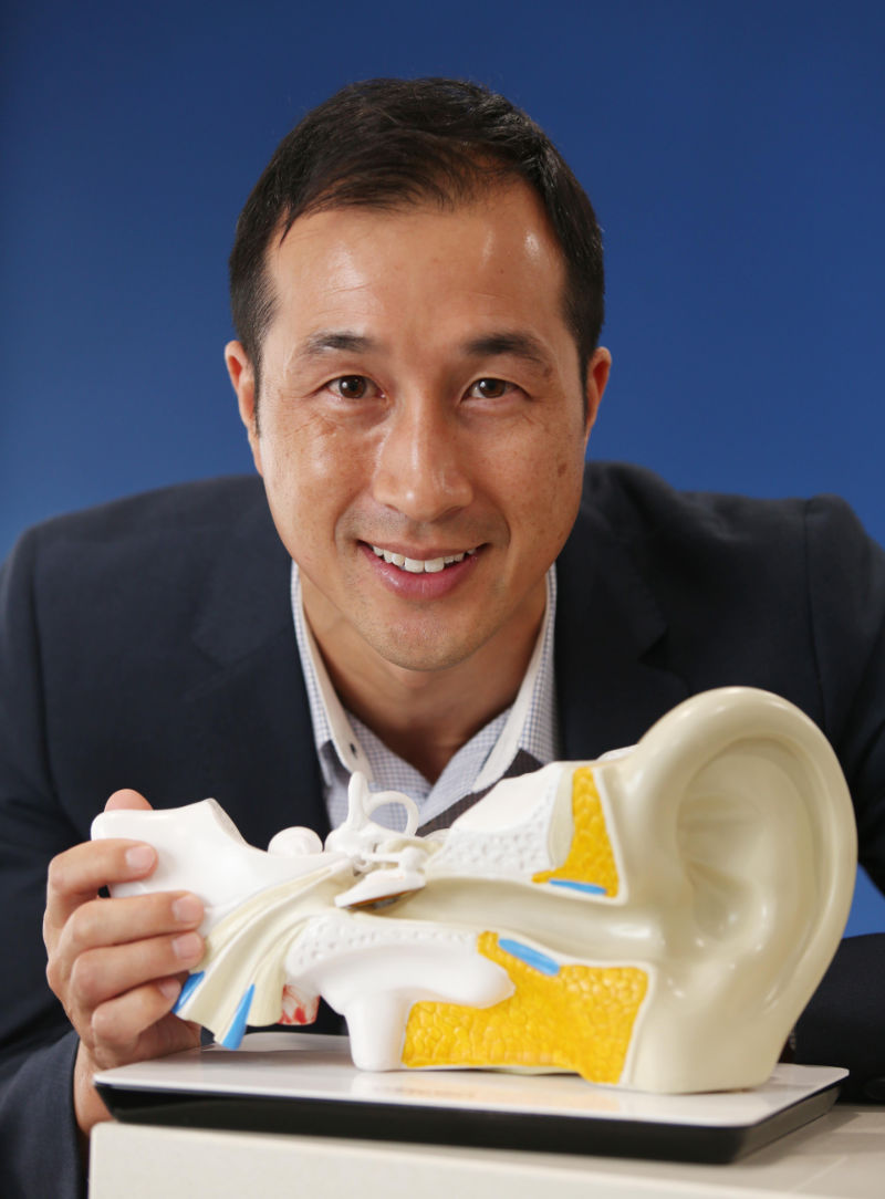 Michael Wong audiologist with ear model